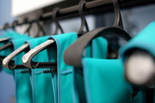 Teal garments on hangers